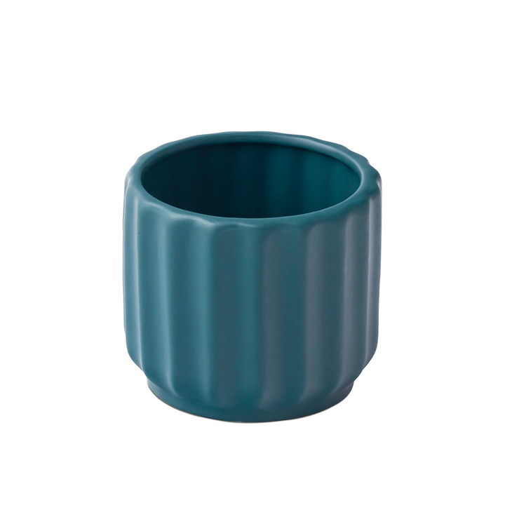 Handcrafted from high-quality ceramic, our Wave Whisperer planter is designed for indoor plants, bringing a whisper of style to your home decor with its intricate fluted design.