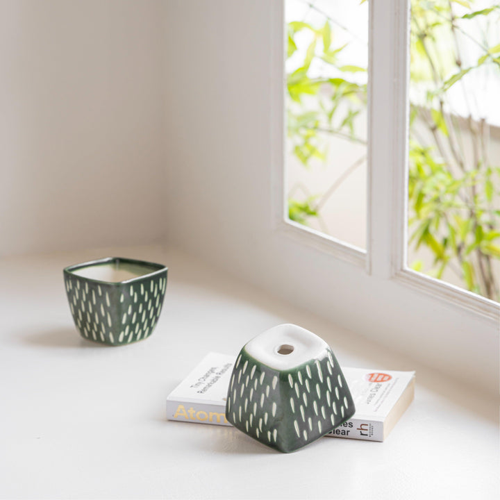 Display image of Square green ceramic planter with a unique teardrop pattern and a smooth matte finish.