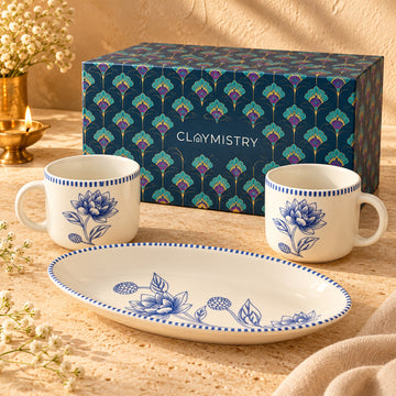 Indigo Bloom blue floral porcelain mug and tray set with the Claymistry navy patterned gift box on ivory stone.