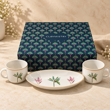 Palms Slow Morning gift set with two white porcelain palm-print mugs, matching oval tray and navy Claymistry gift box on a warm ivory background.