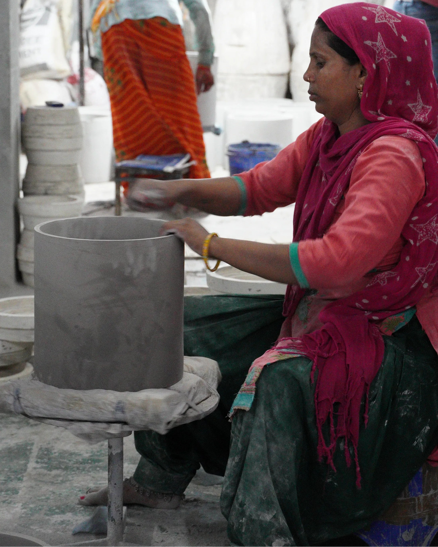 Woman working with clay in a pottery workshop