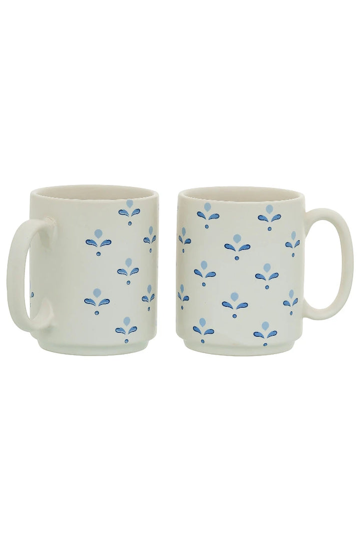 Two ceramic mugs with blue floral patterns on a white background