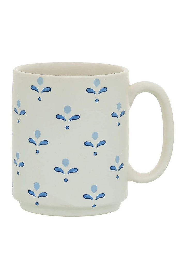 White mug with blue floral patterns on a white background
