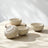 Artistic shot of Golden Dawn ceramic decorative bowls with dramatic shadows, highlighting their beauty as premium, artisanal home decor pieces for a sophisticated home.