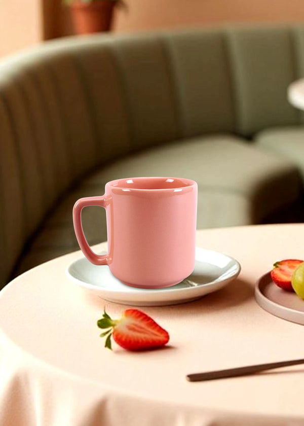 Pink mug on a table with strawberries and a blurred background