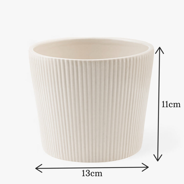 A ceramic planter named 'Shape Shift Planter: The Trapezoid Touchwith' with ribbed texture. The dimensions are labeled: 13 cm wide and 11 cm tall.