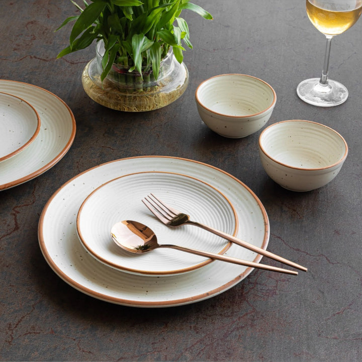 Aesthetic sand speckled ceramic dinner set with bowls and plates, safe and handmade with care.