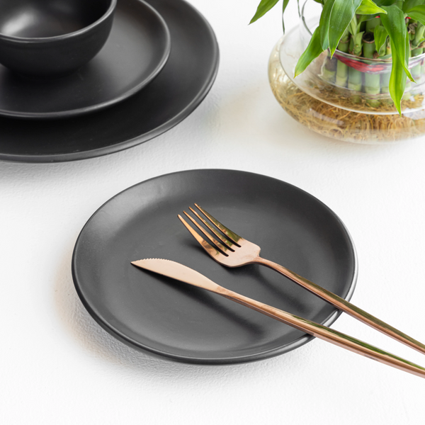 Durable black ceramic dinnerware set, non-toxic and handmade for beautiful, everyday dining style.