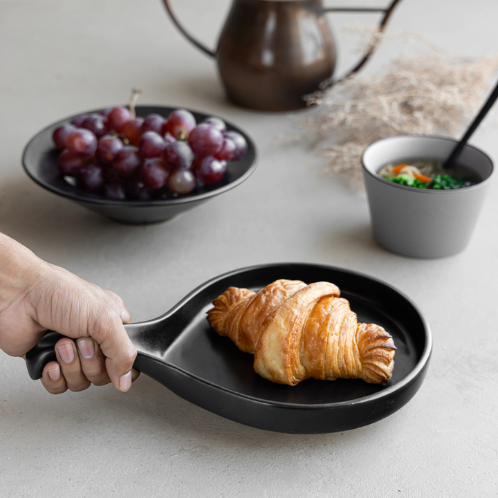 Elegant black ceramic platter with handle, non-toxic and artisan-crafted for modern homes.