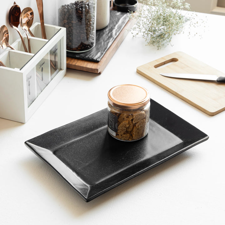 Lead-free black ceramic trays in two sizes, sleek, handmade and perfect for stylish homes.