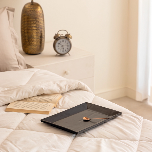 Handmade matte black ceramic trays in 2 sizes, non-toxic and spill-proof for elegant serving.