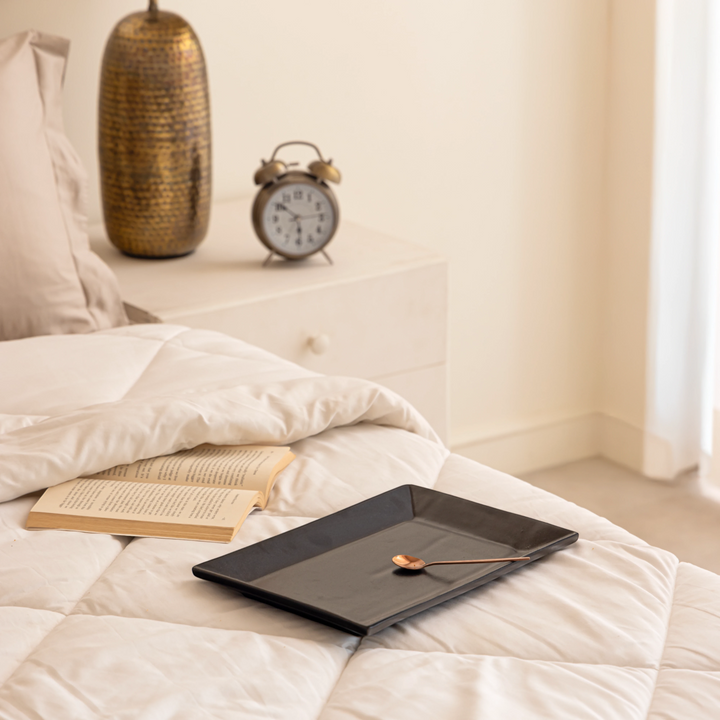 Handmade matte black ceramic trays in 2 sizes, non-toxic and spill-proof for elegant serving.