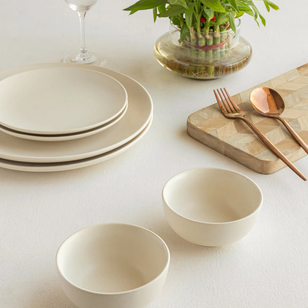 Artisan-crafted white ceramic dinnerware set with plates and bowl for sophisticated dining.
