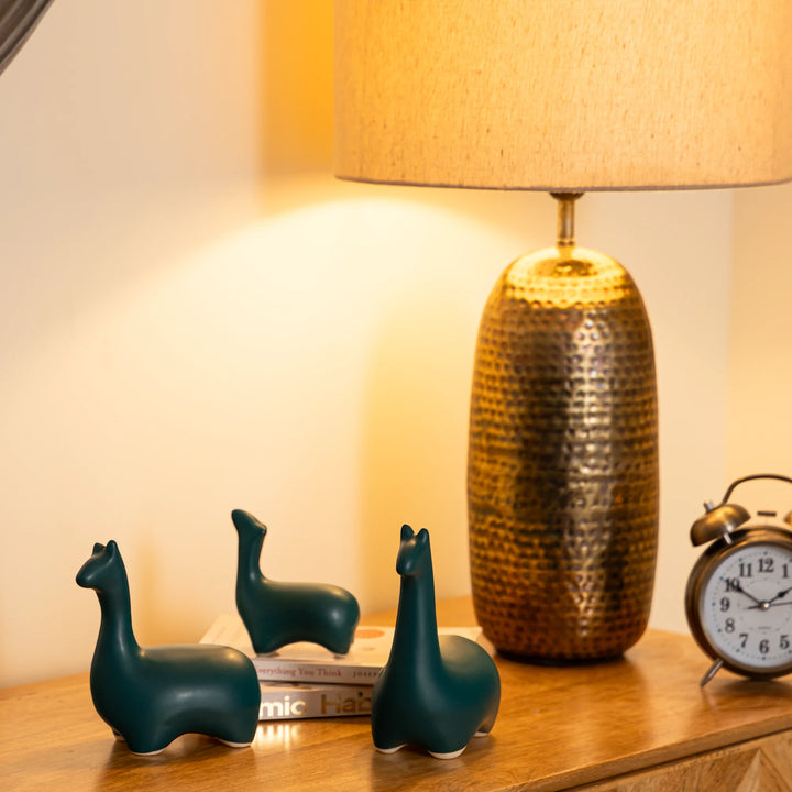Handmade sea green ceramic dinosaur figurine set, perfect for bookshelf or quirky desk decor.