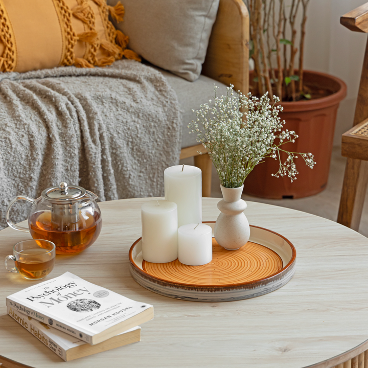 Colorful round ceramic tray with raised edges, durable and safe for drinks and decor display.