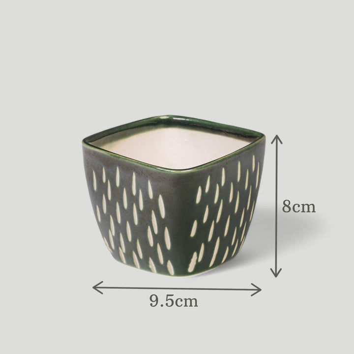 Display image of Square green ceramic planter with a unique teardrop pattern and a smooth matte finish.