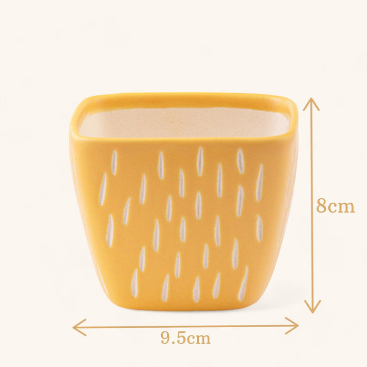 Display image of Square yellow ceramic planter with a unique teardrop pattern and a smooth matte finish.