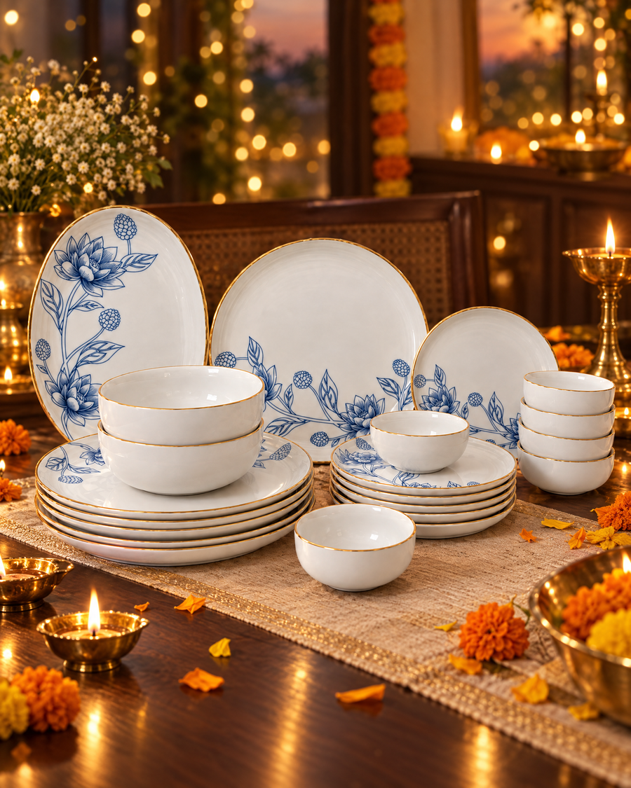 Gold Lotus porcelain dinner set on a Diwali dinner table with brass diyas and marigolds