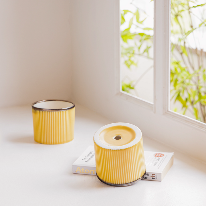 Durable ceramic planter in sunset yellow, perfect for bedrooms and living rooms with plants