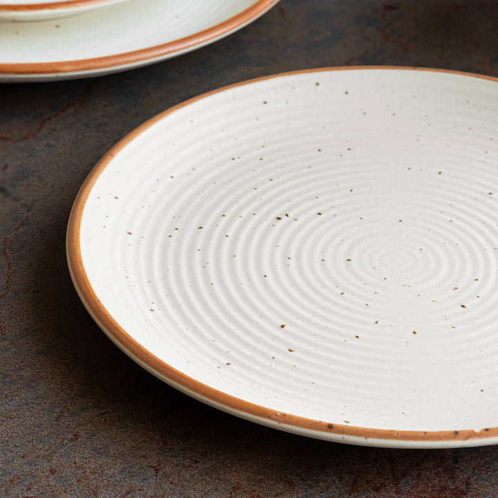 Sandy-toned ceramic plate crafted by Indian artisans with speckled and sandy glaze
