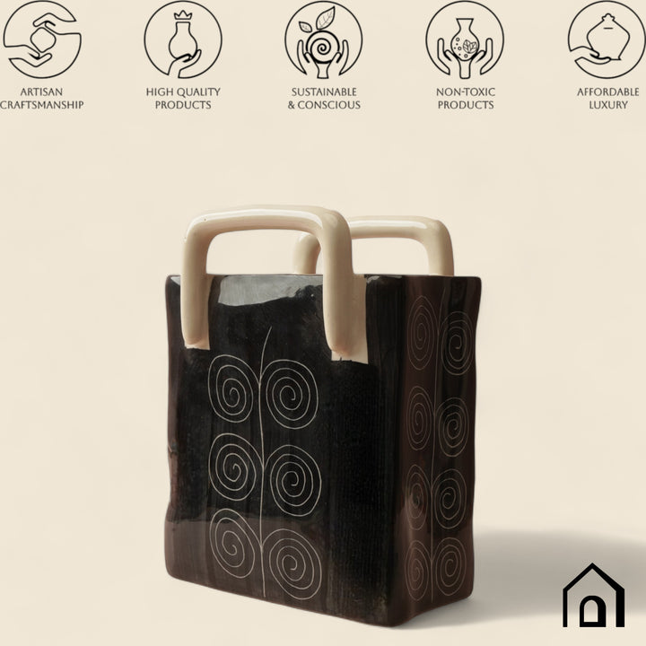 Handmade black ceramic basket with glazed finish and sand handle, safe and beautiful for any room.