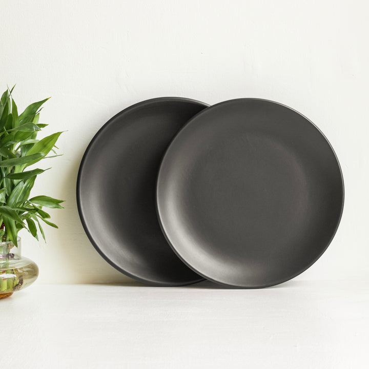 Elegant black ceramic dinner set, lead-free and dishwasher safe with timeless artisan beauty.