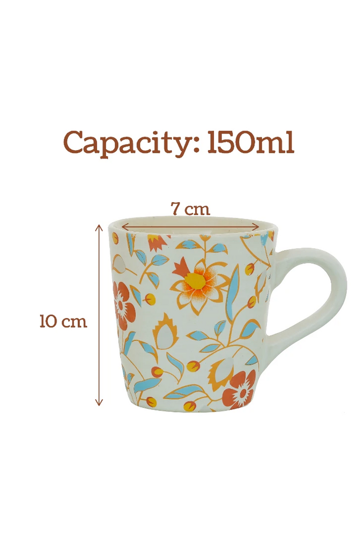Floral-patterned mug with measurements on a white background
