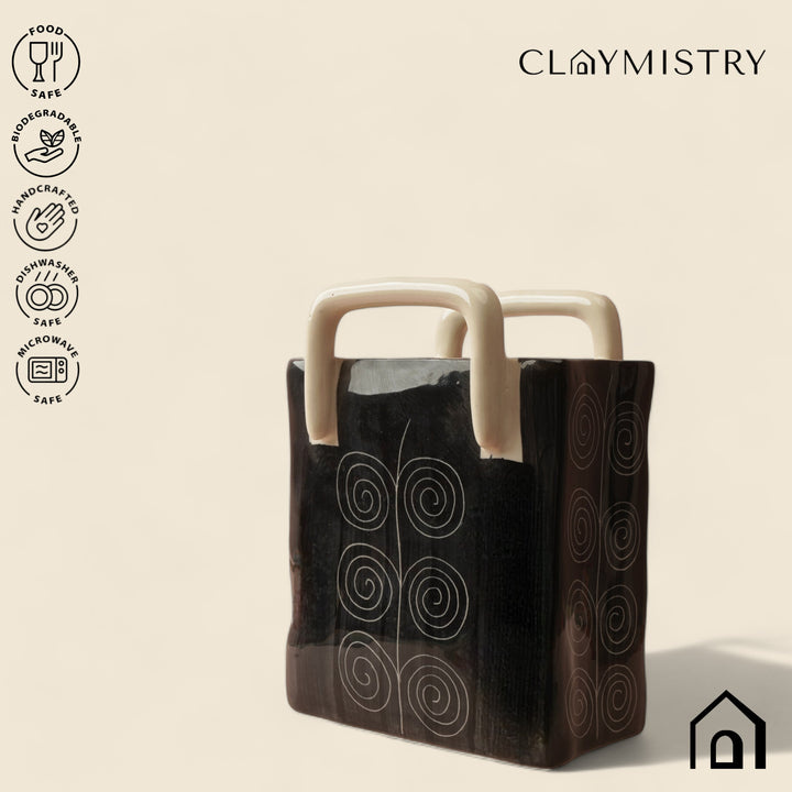 Pretty black ceramic storage basket with sand handle, lead-free and perfect for minimalist spaces.