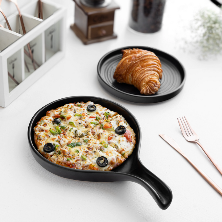 Round black ceramic pan-style platter, microwave safe and perfect for elegant table setting. Perfect for pizza and croissant.