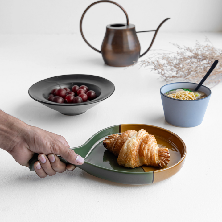 Durable round ceramic platter in green and gold, with raised edges and fine handcrafted glaze.