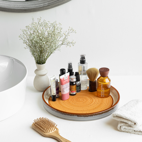 Handmade round ceramic tray in orange, brown & white, non-toxic and safe for organising your space.