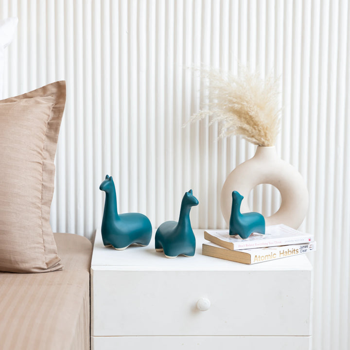 Whimsical handcrafted ceramic dinosaur figurines in sea green, great for pretty room styling.