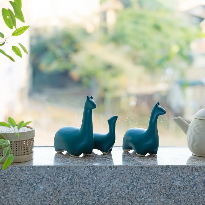 Handcrafted sea green dinosaur trio in ceramic, ideal for adding charm to modern interiors.
