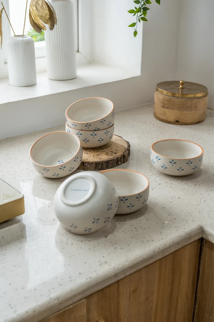 Set of ceramic bowls on a light-colored countertop with a window in the background.