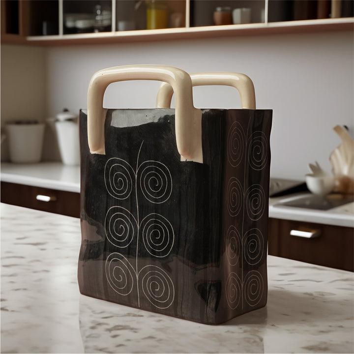 Stylish and durable ceramic basket in black with sand handle, perfect for multipurpose home storage.